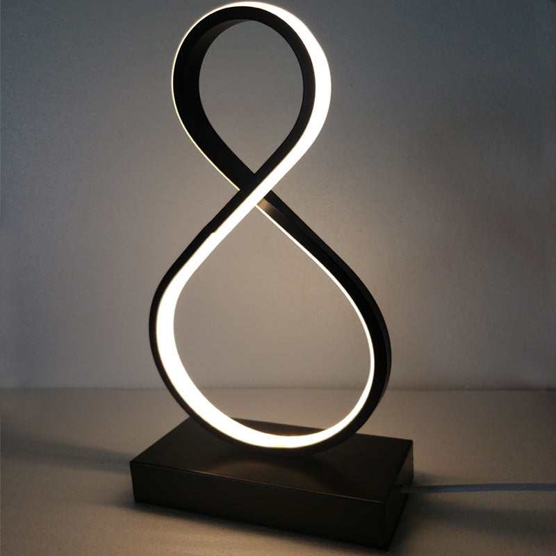 Modern aluminum and iron bedroom bedside lamp with spiral and eight-character designs, LED light, remote control, and adjustable white and warm light.